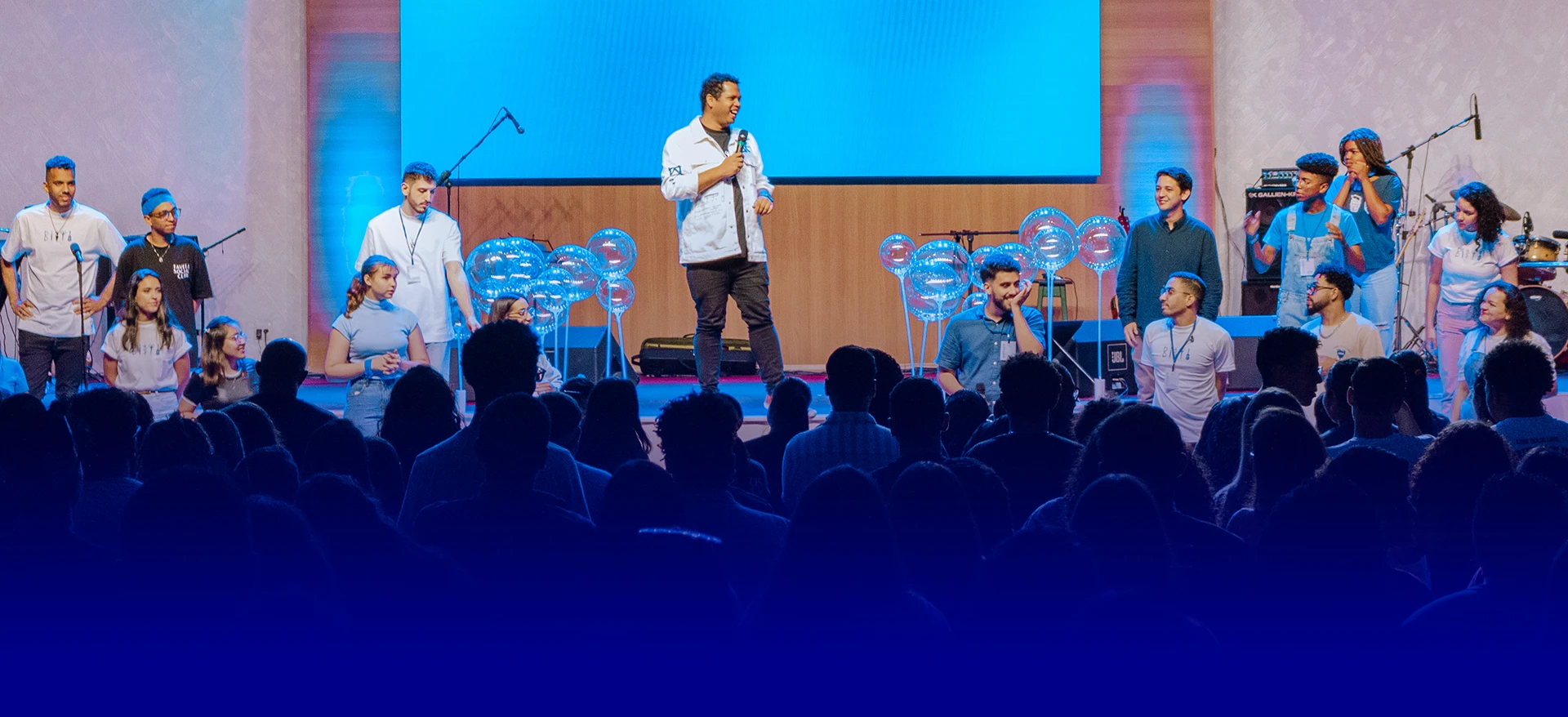 Equipe da Cristãos Criativos em palco de igreja com iluminação azul